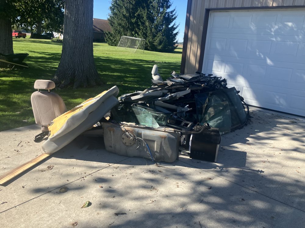 Junk and debris on a driveway ready for JJs Cleanup removal in Portland, IN